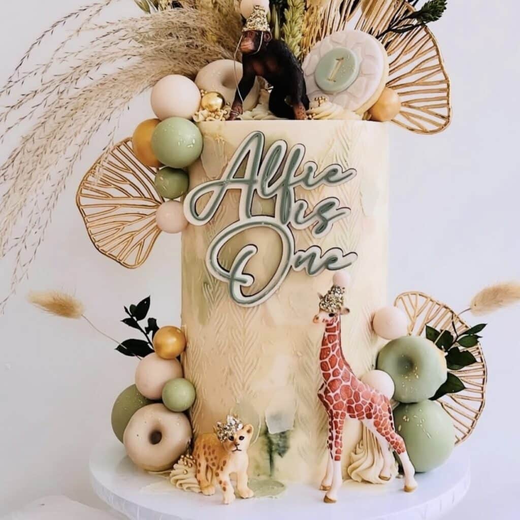 Colorful birthday cake with animals featuring a cake charm laser cut out of acrylic.